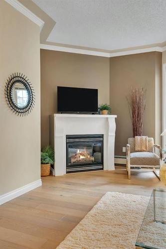 304-1315 12 Avenue Sw, Calgary, AB - Indoor Photo Showing Living Room With Fireplace