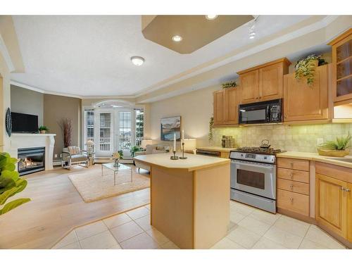 304-1315 12 Avenue Sw, Calgary, AB - Indoor Photo Showing Kitchen With Fireplace