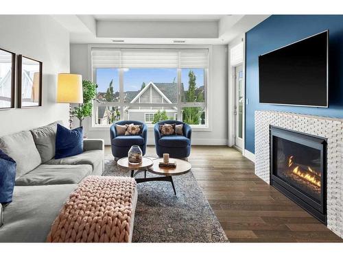 306-33 Burma Star Road Sw, Calgary, AB - Indoor Photo Showing Living Room With Fireplace