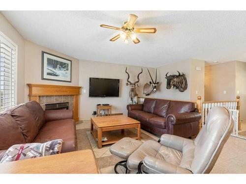 255030 84 Street Ne, Rural Rocky View County, AB - Indoor Photo Showing Living Room With Fireplace