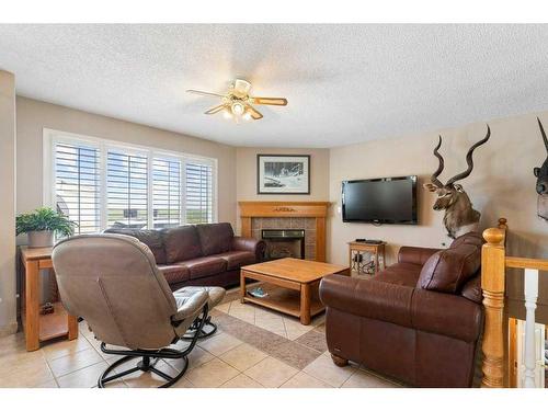 255030 84 Street Ne, Rural Rocky View County, AB - Indoor Photo Showing Living Room With Fireplace