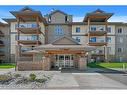 1310-92 Crystal Shores Road, Okotoks, AB  - Outdoor With Balcony With Facade 