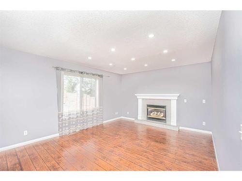 681 Coventry Drive, Calgary, AB - Indoor Photo Showing Living Room With Fireplace