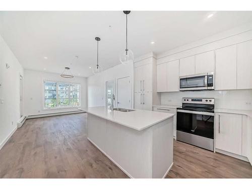 2211-681 Savanna Boulevard Ne, Calgary, AB - Indoor Photo Showing Kitchen With Stainless Steel Kitchen With Double Sink With Upgraded Kitchen