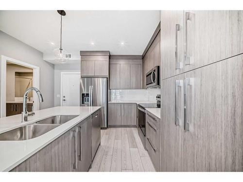 2219-681 Savanna Boulevard, Calgary, AB - Indoor Photo Showing Kitchen With Stainless Steel Kitchen With Double Sink With Upgraded Kitchen