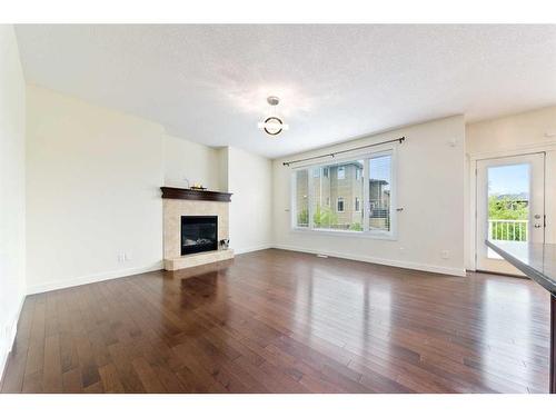 406 Silverado Way Sw, Calgary, AB - Indoor Photo Showing Living Room With Fireplace