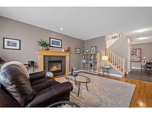 134 Copperstone Close Se, Calgary, AB - Indoor Photo Showing Living Room With Fireplace