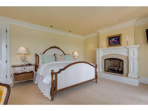 12235 Lake Louise Way Se, Calgary, AB - Indoor Photo Showing Bedroom With Fireplace