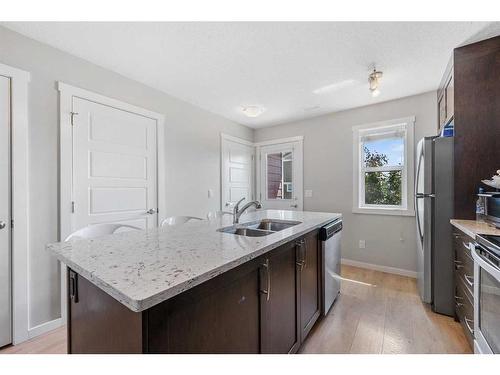 618 Cranford Mews Se, Calgary, AB - Indoor Photo Showing Kitchen With Double Sink