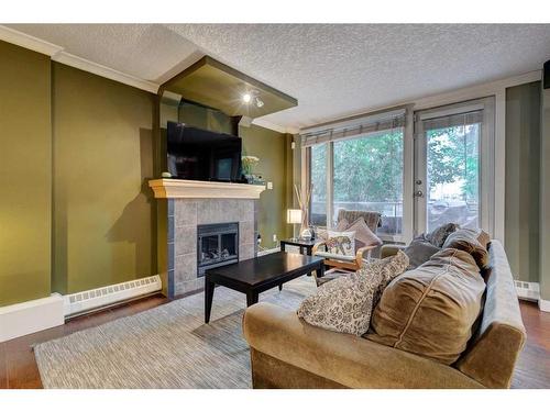 102-1225 15 Avenue Sw, Calgary, AB - Indoor Photo Showing Living Room With Fireplace