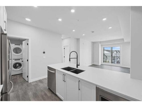 324-255 Les Jardins Park Se, Calgary, AB - Indoor Photo Showing Kitchen With Double Sink