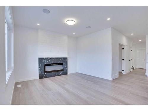 51 Heritage Circle, Cochrane, AB - Indoor Photo Showing Living Room With Fireplace