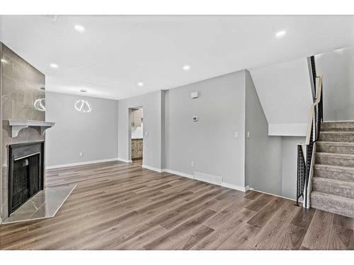 13-2519 38 Street Ne, Calgary, AB - Indoor Photo Showing Other Room With Fireplace