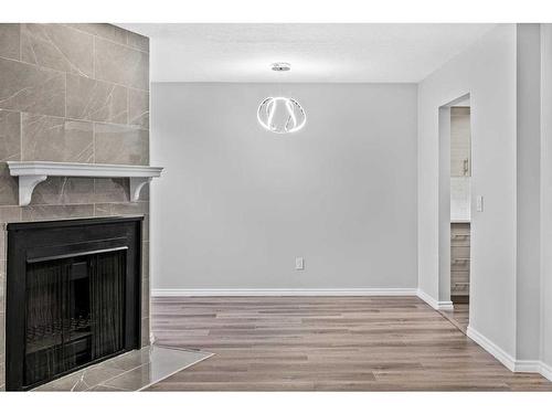 13-2519 38 Street Ne, Calgary, AB - Indoor Photo Showing Other Room With Fireplace
