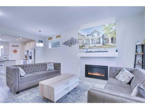 408 South Point Glen Sw, Airdrie, AB - Indoor Photo Showing Living Room With Fireplace