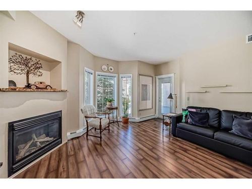 251-223 Tuscany Springs Boulevard Nw, Calgary, AB - Indoor Photo Showing Living Room With Fireplace