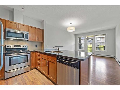 308-76 Panatella Road Nw, Calgary, AB - Indoor Photo Showing Kitchen With Stainless Steel Kitchen With Double Sink