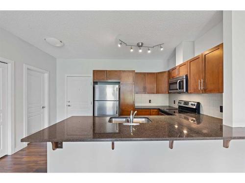 308-76 Panatella Road Nw, Calgary, AB - Indoor Photo Showing Kitchen With Stainless Steel Kitchen With Double Sink