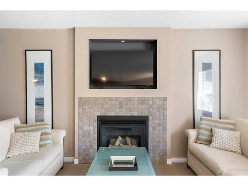 69 Bridleridge View Sw, Calgary, AB - Indoor Photo Showing Living Room With Fireplace