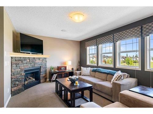 69 Bridleridge View Sw, Calgary, AB - Indoor Photo Showing Living Room With Fireplace