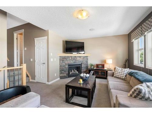 69 Bridleridge View Sw, Calgary, AB - Indoor Photo Showing Living Room With Fireplace