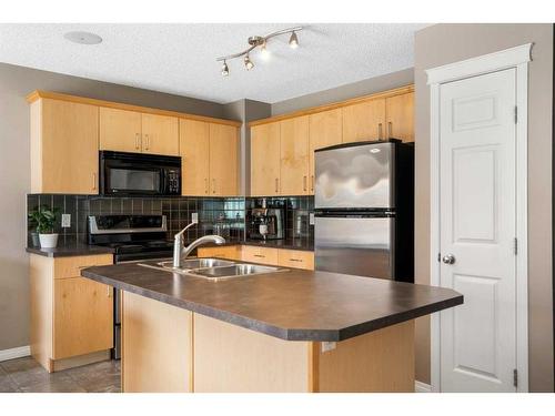 69 Bridleridge View Sw, Calgary, AB - Indoor Photo Showing Kitchen With Double Sink