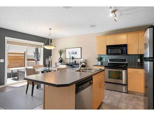 69 Bridleridge View Sw, Calgary, AB - Indoor Photo Showing Kitchen With Stainless Steel Kitchen With Double Sink