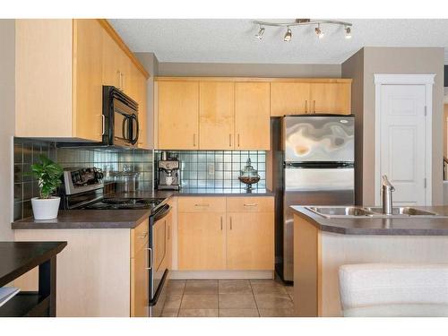 69 Bridleridge View Sw, Calgary, AB - Indoor Photo Showing Kitchen With Double Sink