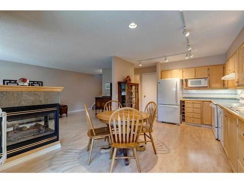 10-2323 Oakmoor Drive Sw, Calgary, AB - Indoor With Fireplace