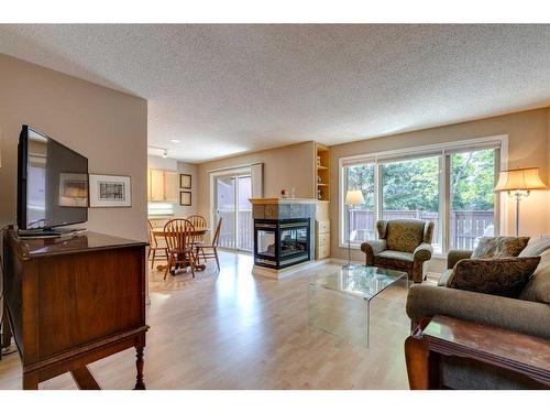 10-2323 Oakmoor Drive Sw, Calgary, AB - Indoor Photo Showing Living Room With Fireplace