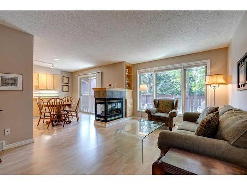 10-2323 Oakmoor Drive Sw, Calgary, AB - Indoor Photo Showing Living Room With Fireplace