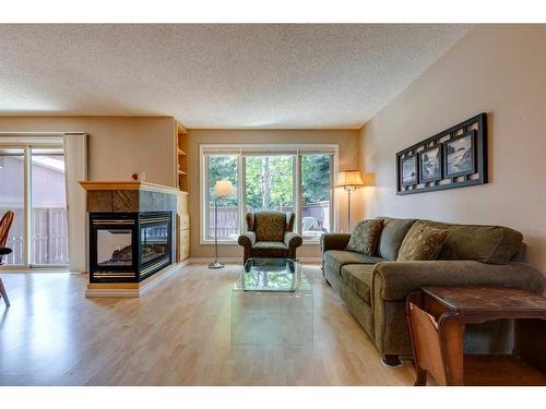 10-2323 Oakmoor Drive Sw, Calgary, AB - Indoor Photo Showing Living Room With Fireplace