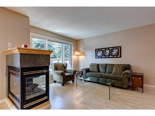 10-2323 Oakmoor Drive Sw, Calgary, AB - Indoor Photo Showing Living Room With Fireplace