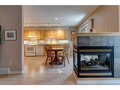 10-2323 Oakmoor Drive Sw, Calgary, AB - Indoor Photo Showing Living Room With Fireplace