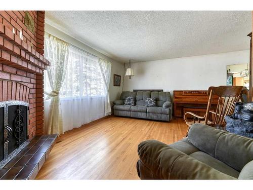 56 Huntwick Way Ne, Calgary, AB - Indoor Photo Showing Living Room With Fireplace