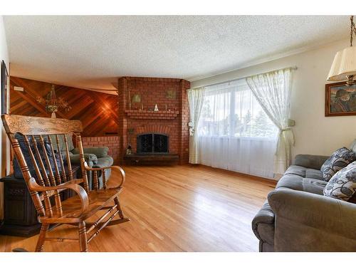 56 Huntwick Way Ne, Calgary, AB - Indoor Photo Showing Living Room With Fireplace