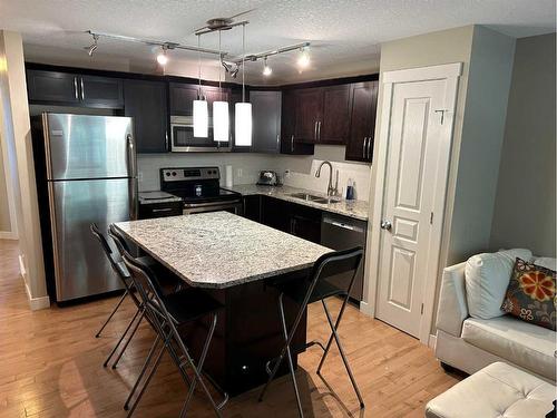 810 Mckenzie Towne Common Se, Calgary, AB - Indoor Photo Showing Kitchen With Stainless Steel Kitchen With Double Sink