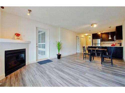 438-35 Richard Court Sw, Calgary, AB - Indoor Photo Showing Living Room With Fireplace