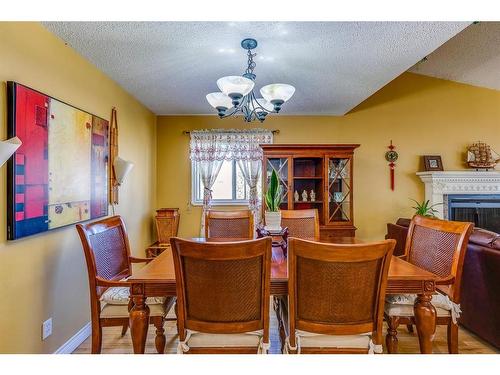 4 Cedargrove Road Sw, Calgary, AB - Indoor Photo Showing Dining Room With Fireplace