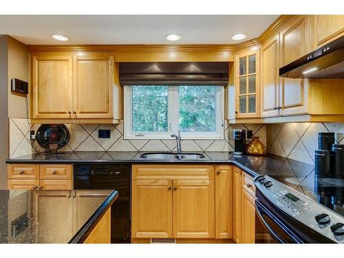 16 Woodfield Way Sw, Calgary, AB - Indoor Photo Showing Kitchen With Double Sink