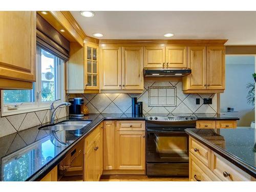 16 Woodfield Way Sw, Calgary, AB - Indoor Photo Showing Kitchen With Double Sink