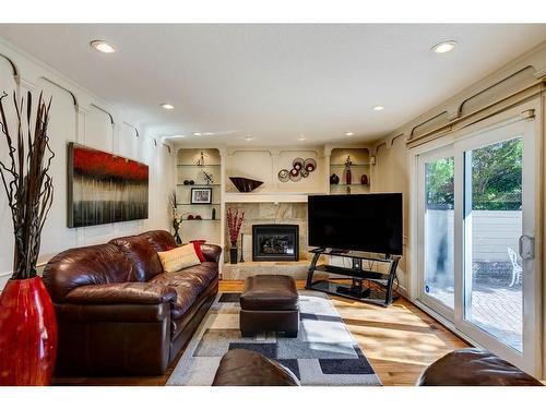 16 Woodfield Way Sw, Calgary, AB - Indoor Photo Showing Living Room With Fireplace