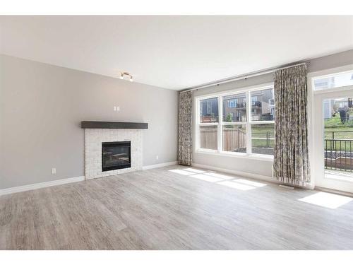 176 Hillcrest Drive Sw, Airdrie, AB - Indoor Photo Showing Living Room With Fireplace