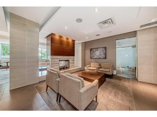 412-51 Waterfront Mews Sw, Calgary, AB - Indoor With Fireplace