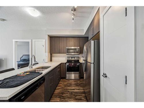 106-605 17 Avenue Nw, Calgary, AB - Indoor Photo Showing Kitchen With Stainless Steel Kitchen With Double Sink With Upgraded Kitchen