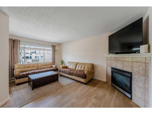 72 Crystal Shores Cove, Okotoks, AB - Indoor Photo Showing Living Room With Fireplace