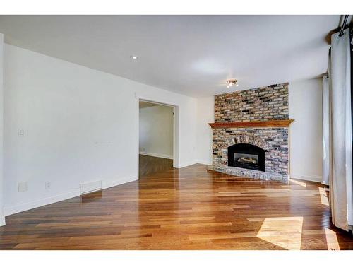 82 Edgebank Circle Nw, Calgary, AB - Indoor Photo Showing Living Room With Fireplace