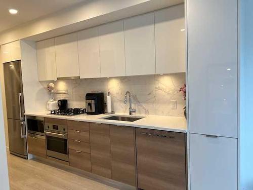 602-108 Waterfront Court Sw, Calgary, AB - Indoor Photo Showing Kitchen With Stainless Steel Kitchen With Upgraded Kitchen