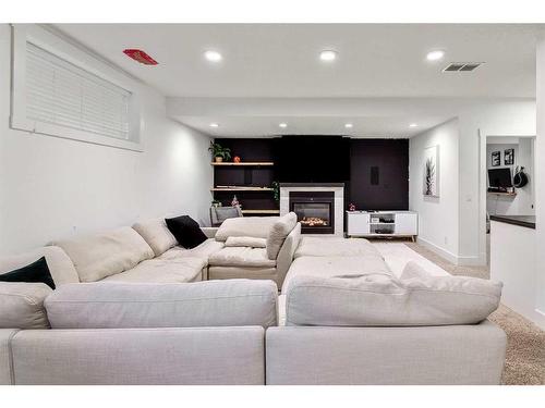 270 Discovery Ridge Way Sw, Calgary, AB - Indoor Photo Showing Living Room With Fireplace