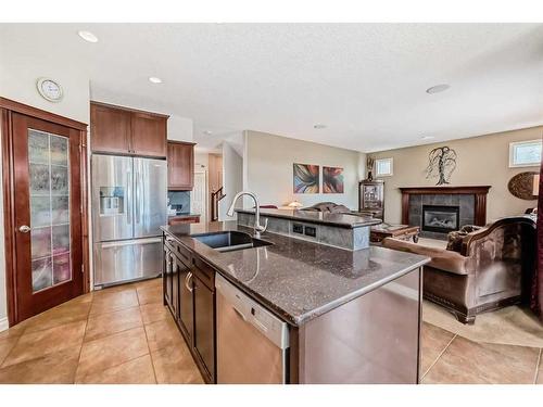 51 Billy Haynes Trail, Okotoks, AB - Indoor Photo Showing Kitchen With Fireplace With Double Sink